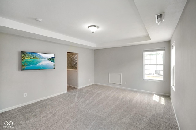 6830 Park Grove Blvd, Whitestown, IN 46075 - carpeted empty room featuring a tray ceiling, baseboards, and a smoke detector