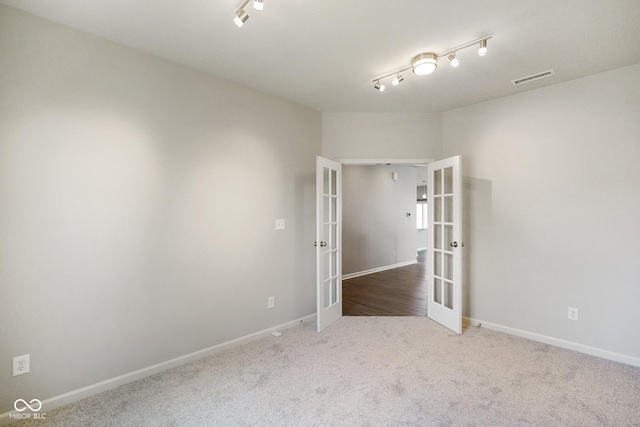 6830 Park Grove Blvd, Whitestown, IN 46075 - carpeted empty room featuring french doors, baseboards, and track lighting