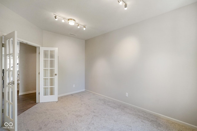 6830 Park Grove Blvd, Whitestown, IN 46075 - carpeted spare room featuring french doors, track lighting, and baseboards