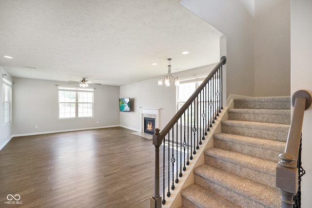 6830 Park Grove Blvd, Whitestown, IN 46075 - staircase with wood finished floors, ceiling fan, baseboards, recessed lighting, and a tile fireplace