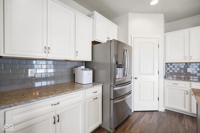 6830 Park Grove Blvd, Whitestown, IN 46075 - kitchen featuring stainless steel refrigerator with ice dispenser, white cabinetry, decorative backsplash, dark wood-style floors, and light stone counters