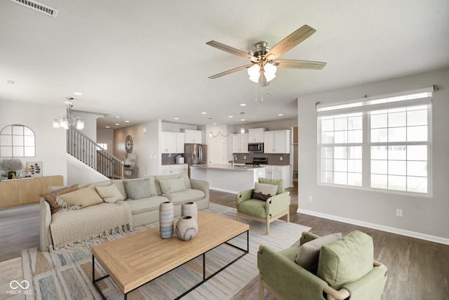 6830 Park Grove Blvd, Whitestown, IN 46075 - living area featuring ceiling fan, healthy amount of natural light, dark wood-style flooring, a chandelier, and recessed lighting