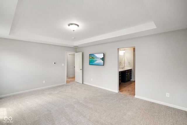6830 Park Grove Blvd, Whitestown, IN 46075 - unfurnished bedroom with a tray ceiling, light colored carpet, and baseboards
