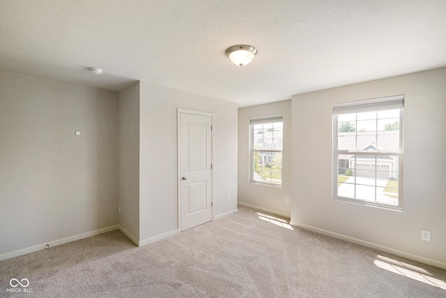 6830 Park Grove Blvd, Whitestown, IN 46075 - spare room with carpet flooring, baseboards, and a textured ceiling