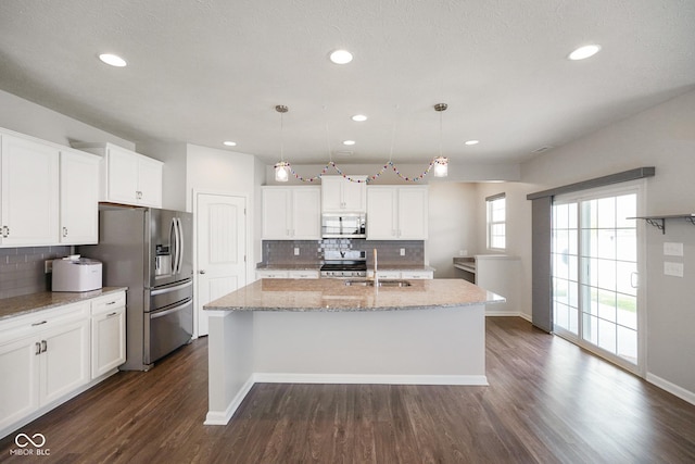 6830 Park Grove Blvd, Whitestown, IN 46075 - kitchen featuring appliances with stainless steel finishes, an island with sink, dark wood-style floors, decorative backsplash, and recessed lighting