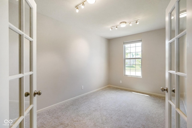 6830 Park Grove Blvd, Whitestown, IN 46075 - carpeted empty room featuring french doors, baseboards, and rail lighting