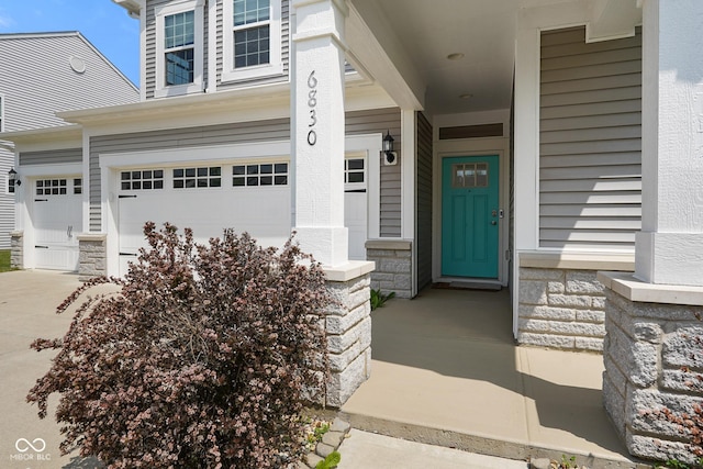 6830 Park Grove Blvd, Whitestown, IN 46075 - entrance to property with a garage, stone siding, and concrete driveway