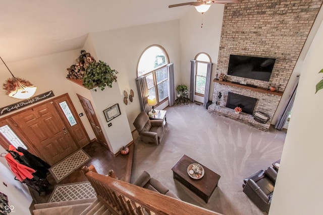 3819 S Village Dr, New Palestine, IN 46163 - living area featuring high vaulted ceiling, baseboards, a brick fireplace, and ceiling fan
