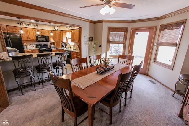 3819 S Village Dr, New Palestine, IN 46163 - dining area featuring light colored carpet, ceiling fan, ornamental molding, and baseboards
