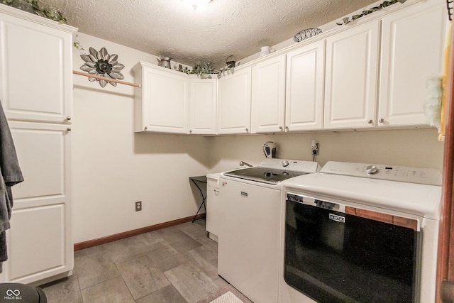 3819 S Village Dr, New Palestine, IN 46163 - laundry area featuring separate washer and dryer, a textured ceiling, cabinet space, and baseboards