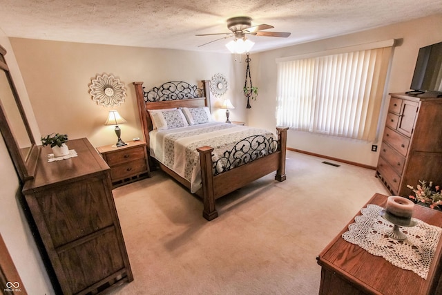 3819 S Village Dr, New Palestine, IN 46163 - bedroom with light carpet, a textured ceiling, baseboards, and a ceiling fan