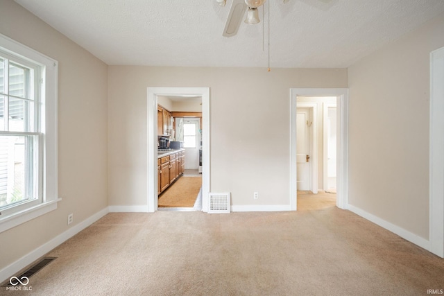 2007 Lincoln Ave, New Castle, IN 47362 - spare room with light carpet, ceiling fan, baseboards, and a textured ceiling