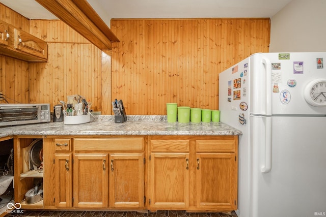 2007 Lincoln Ave, New Castle, IN 47362 - kitchen with freestanding refrigerator, light countertops, and wood walls
