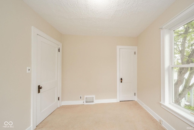 2007 Lincoln Ave, New Castle, IN 47362 - empty room with light carpet, a textured ceiling, and baseboards