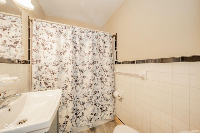 2007 Lincoln Ave, New Castle, IN 47362 - bathroom with tile walls, toilet, a sink, curtained shower, and wood finished floors