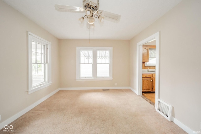 2007 Lincoln Ave, New Castle, IN 47362 - unfurnished room with light carpet, healthy amount of natural light, ceiling fan, and baseboards
