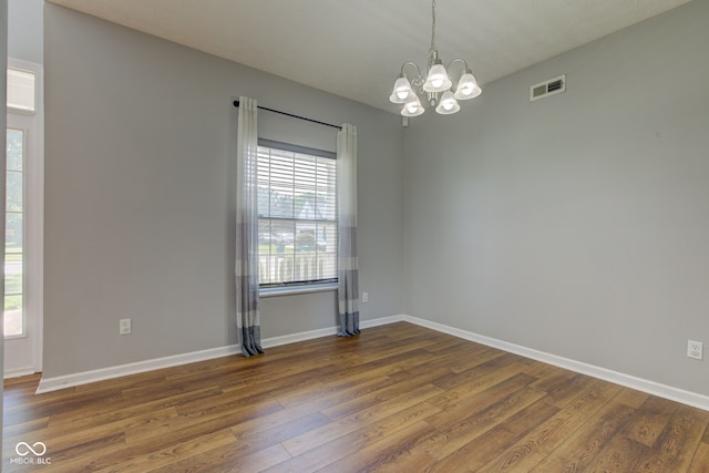 2234 Burgundy Way, Plainfield, IN 46168 - spare room with wood finished floors, a chandelier, and baseboards