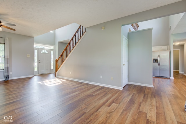 2234 Burgundy Way, Plainfield, IN 46168 - unfurnished living room featuring a ceiling fan, wood finished floors, stairs, and baseboards