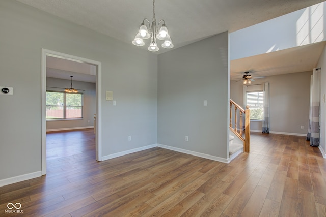 2234 Burgundy Way, Plainfield, IN 46168 - spare room featuring a chandelier, stairs, wood finished floors, and baseboards
