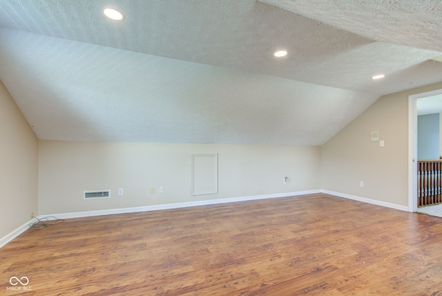 2234 Burgundy Way, Plainfield, IN 46168 - bonus room with a textured ceiling, wood finished floors, baseboards, lofted ceiling, and recessed lighting