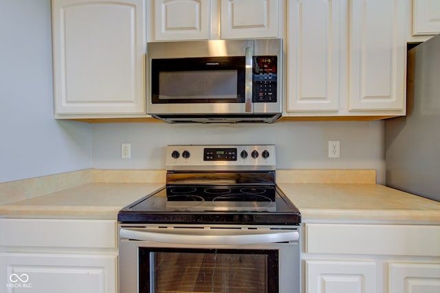 2234 Burgundy Way, Plainfield, IN 46168 - kitchen featuring appliances with stainless steel finishes, white cabinets, and light countertops