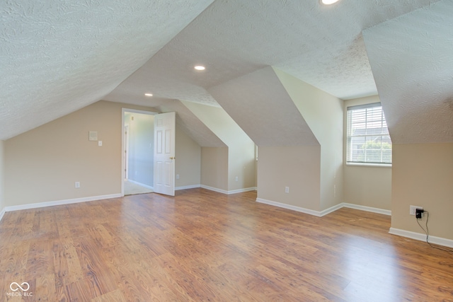 2234 Burgundy Way, Plainfield, IN 46168 - bonus room with a textured ceiling, wood finished floors, recessed lighting, lofted ceiling, and baseboards