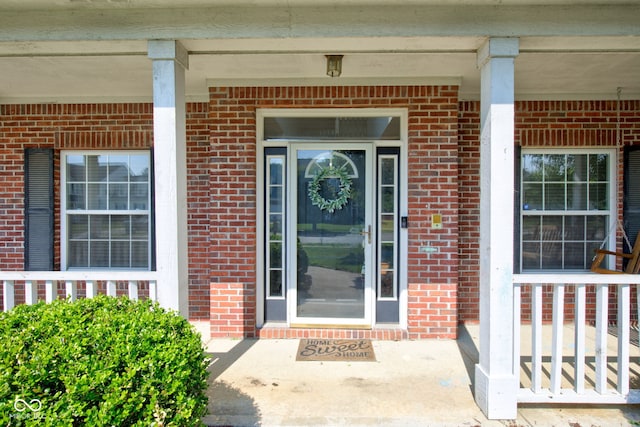 2234 Burgundy Way, Plainfield, IN 46168 - view of exterior entry featuring a porch and brick siding