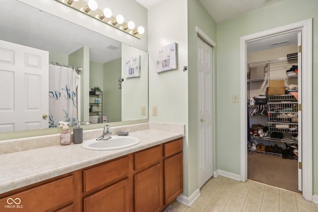 2114 Turning Leaf Dr, Franklin, IN 46131 - full bath featuring vanity, tile patterned floors, baseboards, and a spacious closet