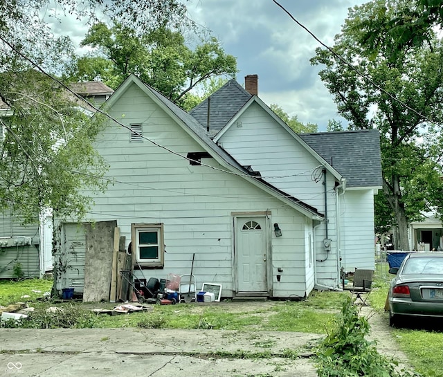 1139 S 7th St, Terre Haute, IN 47802 - rear view of property featuring a chimney and a shingled roof