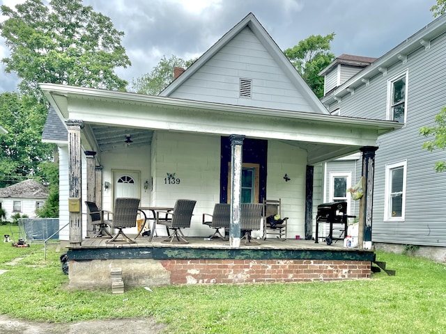 1139 S 7th St, Terre Haute, IN 47802 - back of property featuring covered porch, a yard, and a chimney