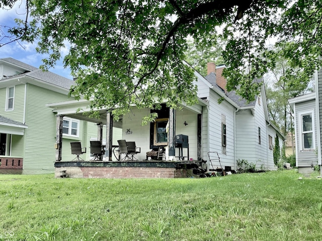 1139 S 7th St, Terre Haute, IN 47802 - back of house with a lawn, a chimney, and a shingled roof