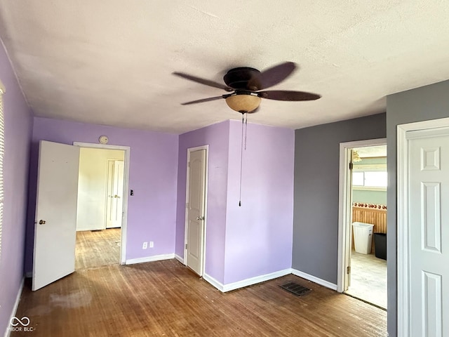 4853 Wentworth Blvd, Indianapolis, IN 46201 - unfurnished bedroom featuring wood finished floors, a textured ceiling, and a ceiling fan