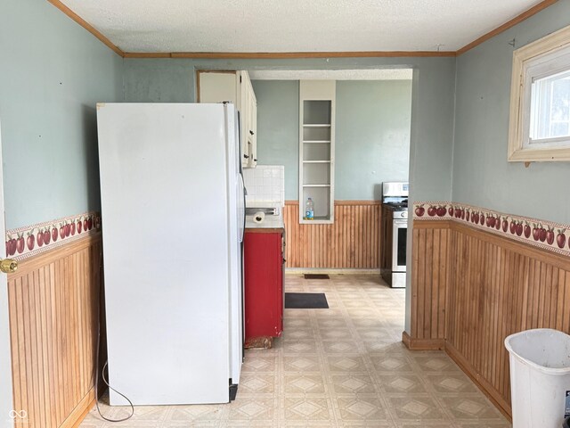 4853 Wentworth Blvd, Indianapolis, IN 46201 - kitchen with white appliances, light floors, a wainscoted wall, wooden walls, and ornamental molding