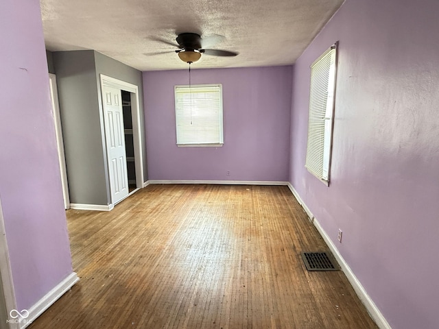 4853 Wentworth Blvd, Indianapolis, IN 46201 - unfurnished bedroom featuring wood finished floors, a textured ceiling, a closet, and ceiling fan