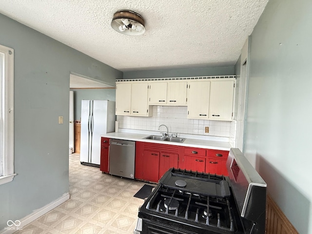 4853 Wentworth Blvd, Indianapolis, IN 46201 - kitchen with dishwasher, freestanding refrigerator, light floors, gas range oven, and light countertops
