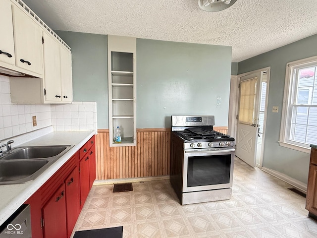 4853 Wentworth Blvd, Indianapolis, IN 46201 - kitchen featuring stainless steel appliances, light countertops, a wainscoted wall, a textured ceiling, and light floors