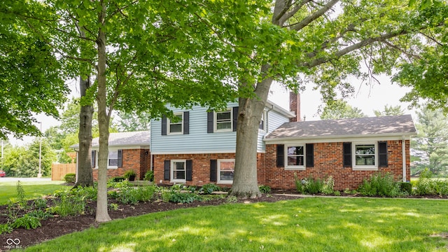 7935 N County Road 650 E, Brownsburg, IN 46112 - tri-level home featuring brick siding, a front lawn, and a chimney