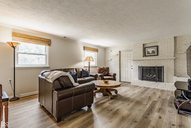 7935 N County Road 650 E, Brownsburg, IN 46112 - living area with wood finished floors, a textured ceiling, plenty of natural light, and a brick fireplace