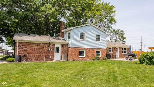 7935 N County Road 650 E, Brownsburg, IN 46112 - rear view of house with a patio, a chimney, and brick siding