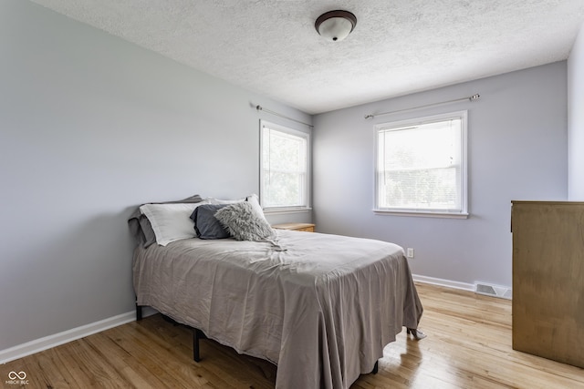 7935 N County Road 650 E, Brownsburg, IN 46112 - bedroom with light wood-type flooring and a textured ceiling