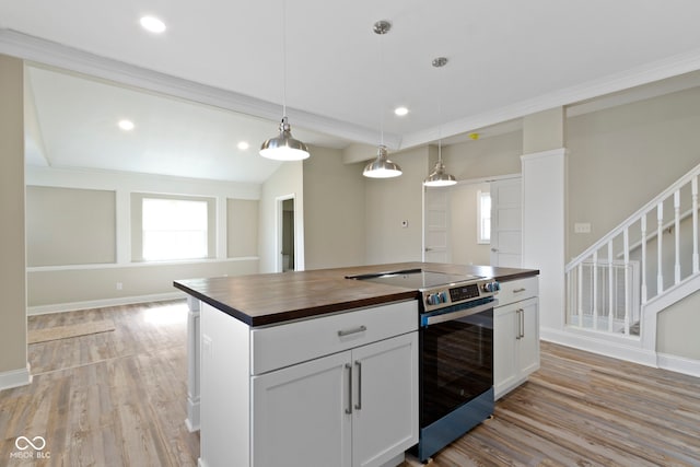 2111 S A St, Elwood, IN 46036 - kitchen with wood counters, electric stove, light wood finished floors, pendant lighting, and baseboards