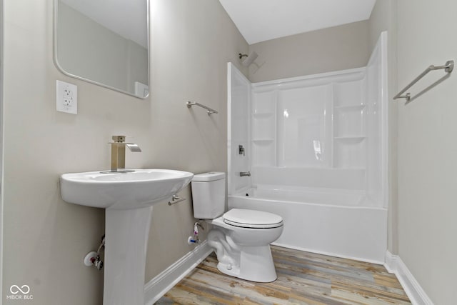 2111 S A St, Elwood, IN 46036 - bathroom featuring toilet, wood finished floors, washtub / shower combination, and baseboards