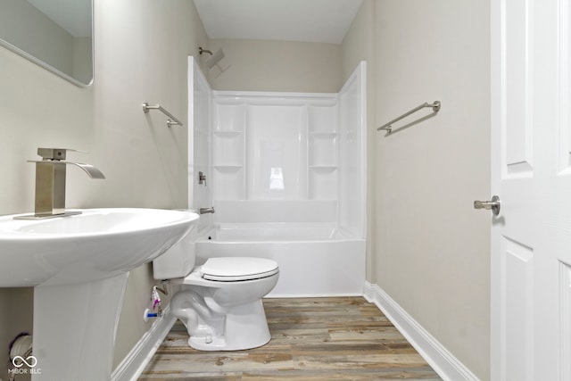 2111 S A St, Elwood, IN 46036 - bathroom featuring wood finished floors, toilet, shower / tub combination, and baseboards