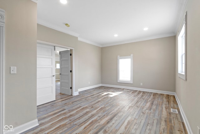 2111 S A St, Elwood, IN 46036 - spare room featuring baseboards, light wood finished floors, ornamental molding, and recessed lighting