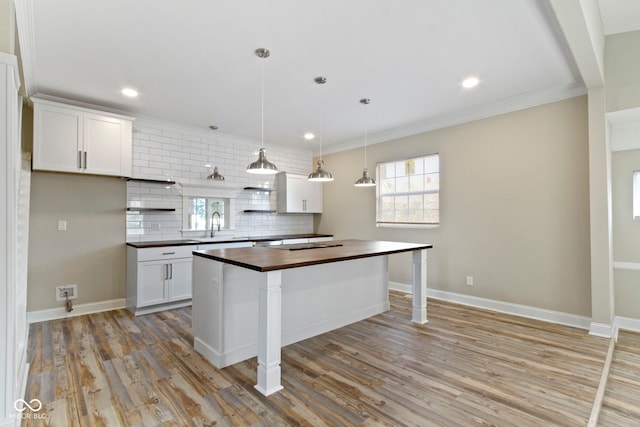 2111 S A St, Elwood, IN 46036 - kitchen featuring wood counters, decorative backsplash, light wood-style flooring, white cabinets, and recessed lighting