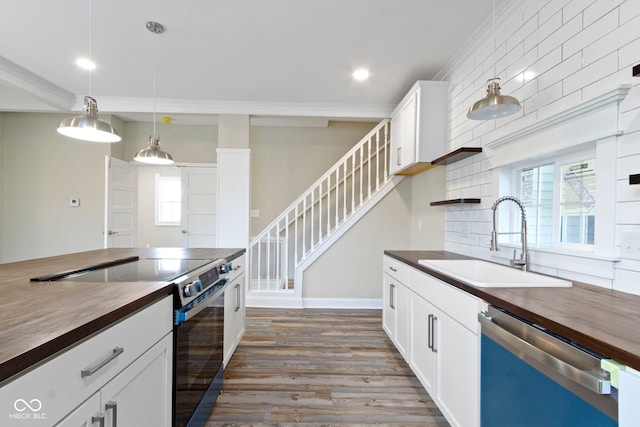 2111 S A St, Elwood, IN 46036 - kitchen with wooden counters, stainless steel appliances, a sink, dark wood-style floors, and white cabinets