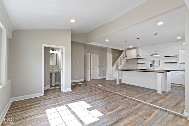 2111 S A St, Elwood, IN 46036 - kitchen with dark countertops, light wood-style flooring, tasteful backsplash, white cabinets, and open shelves