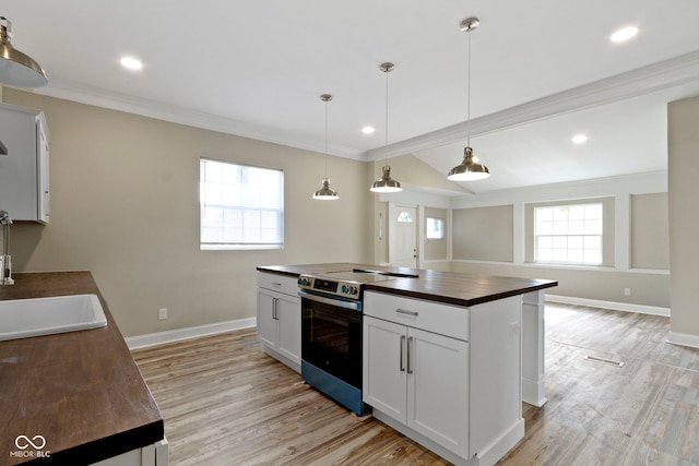 2111 S A St, Elwood, IN 46036 - kitchen featuring butcher block counters, stainless steel range with electric cooktop, baseboards, light wood-type flooring, and a sink