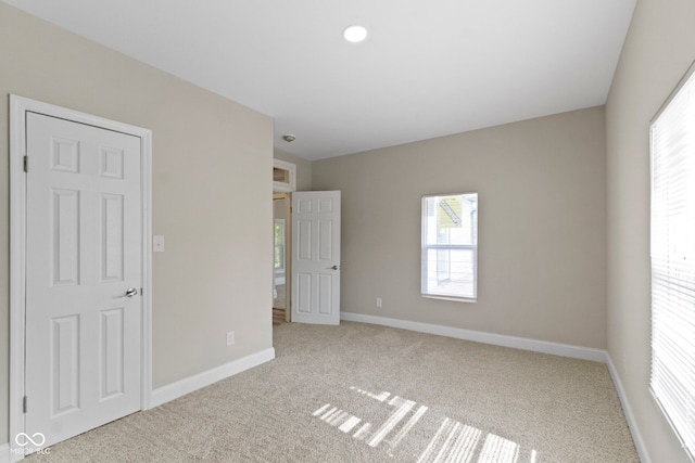 2111 S A St, Elwood, IN 46036 - unfurnished bedroom with carpet floors, multiple windows, and baseboards