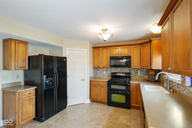 101 Meadowview Dr, Mooresville, IN 46158 - kitchen with black appliances, a sink, brown cabinetry, and tasteful backsplash